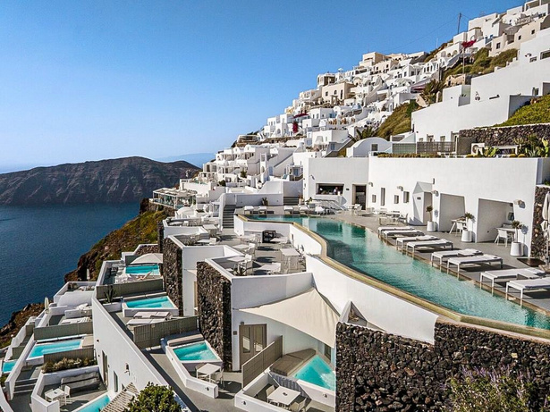 Cliffside infinity pools overlooking the sea at sunset